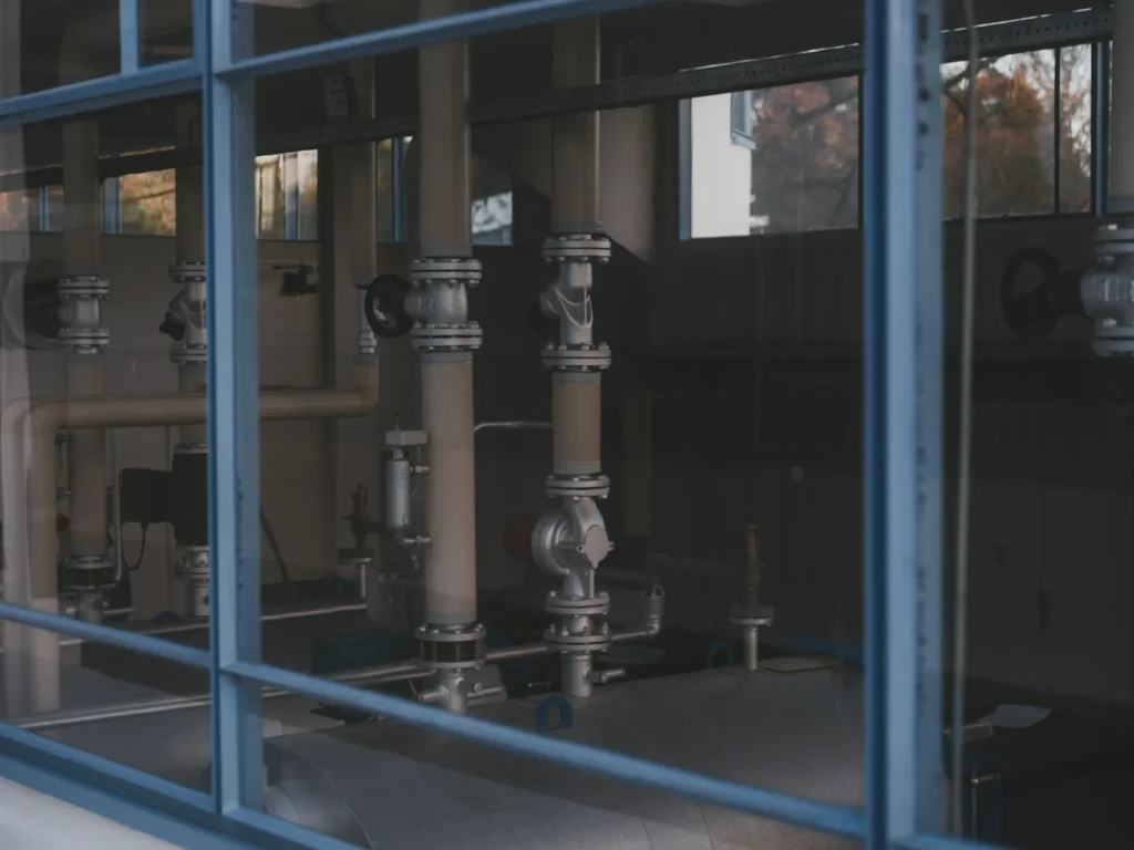 Process piping and valves inside an industrial facility